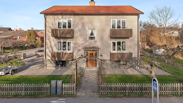A two-story brick building with a red-tiled roof, a central entrance, and a small front garden. - 3 bedroom cozy apartment in Finspång (Finspång)