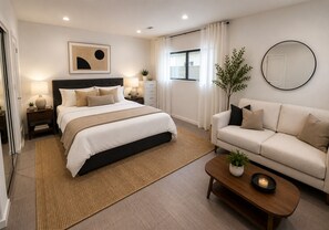 A modern bedroom with a bed, bedside tables, a sofa, a coffee table, and a mirror. - Steps to Beach & 2nd St. Retreat, Hot-Tub, Parking, 3BR w/Private Studio (Long Beach)