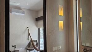 A modern bathroom with a large mirror, a sink, and a window. - Apsara Villas perfect oasis in Tulum (Tulum)