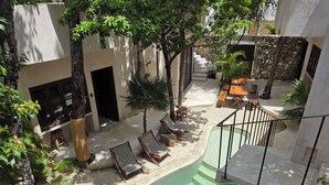 A rooftop pool area with lounge chairs, a staircase, and surrounding greenery. - Apsara Villas perfect oasis in Tulum (Tulum)