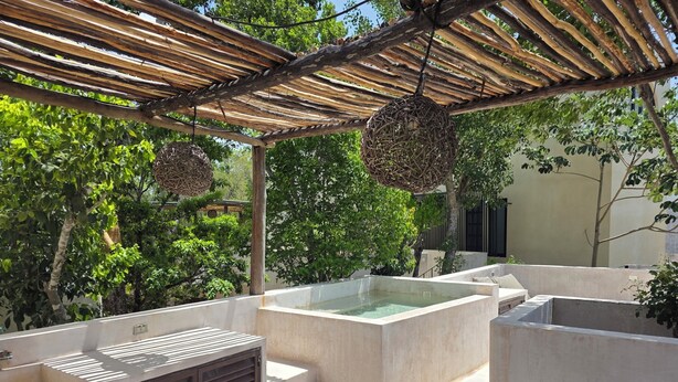 A rooftop patio with a pergola, a hot tub, and a wooden table. - Apsara Villas perfect oasis in Tulum (Tulum)