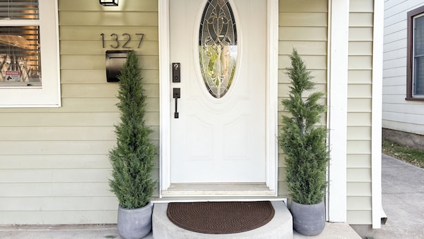 A front door with a number plate, a mailbox, and two potted evergreen trees. - Spacious, Sleeps 16+, Game Room Near Downtown Indianapolis (Indianapolis)