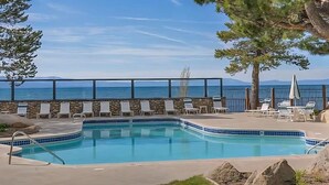 A swimming pool with lounge chairs and a view of the sea. - Beautiful Tahoe Keys Home: Family and Pet Friendly (South Lake Tahoe)