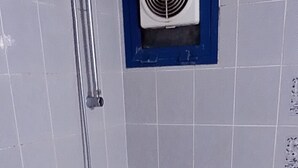 Een badkamer met een toilet, een badkuip en een douche.