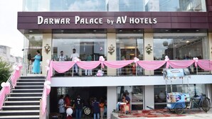 A multi-story hotel with a modern facade, large windows, and a sign reading "Darwar Palace by AV Hotels". - DARWAR PALACE BY AV HOTEL (Bihar Sharif)
