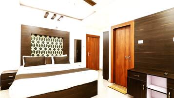 A modern bedroom with a large bed, a wardrobe, and a ceiling fan.