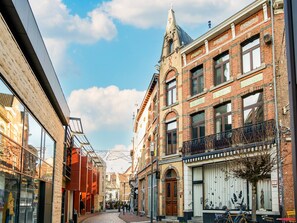 A cobblestone street lined with historic brick buildings, some with balconies and large windows. - Holiday Home in the Heart of Hasselt (Hasselt)