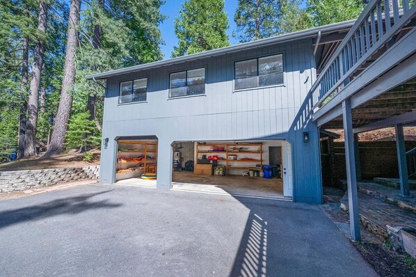 A modern two-story house with a covered garage and a staircase leading to an upper level.
