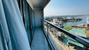 A balcony with a view of a river and buildings. - Hotel Sonar Bangla Rangamati (Rangamati Sadar)