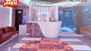 A hotel lobby with a reception desk, a patterned floor design, and a modern interior. - Hotel Sonar Bangla Rangamati (Rangamati Sadar)