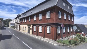 A multi-story building with a symmetrical facade, large windows, and a sloped roof. - Stunning  villa for 4 people with WIFI, pool, TV and pets allowed (Rumburk)