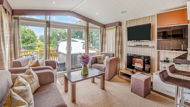 A spacious living area with a large TV, comfortable seating, and a view of the outdoors. - 2 bedroom accommodation in Bala, (Bala,)