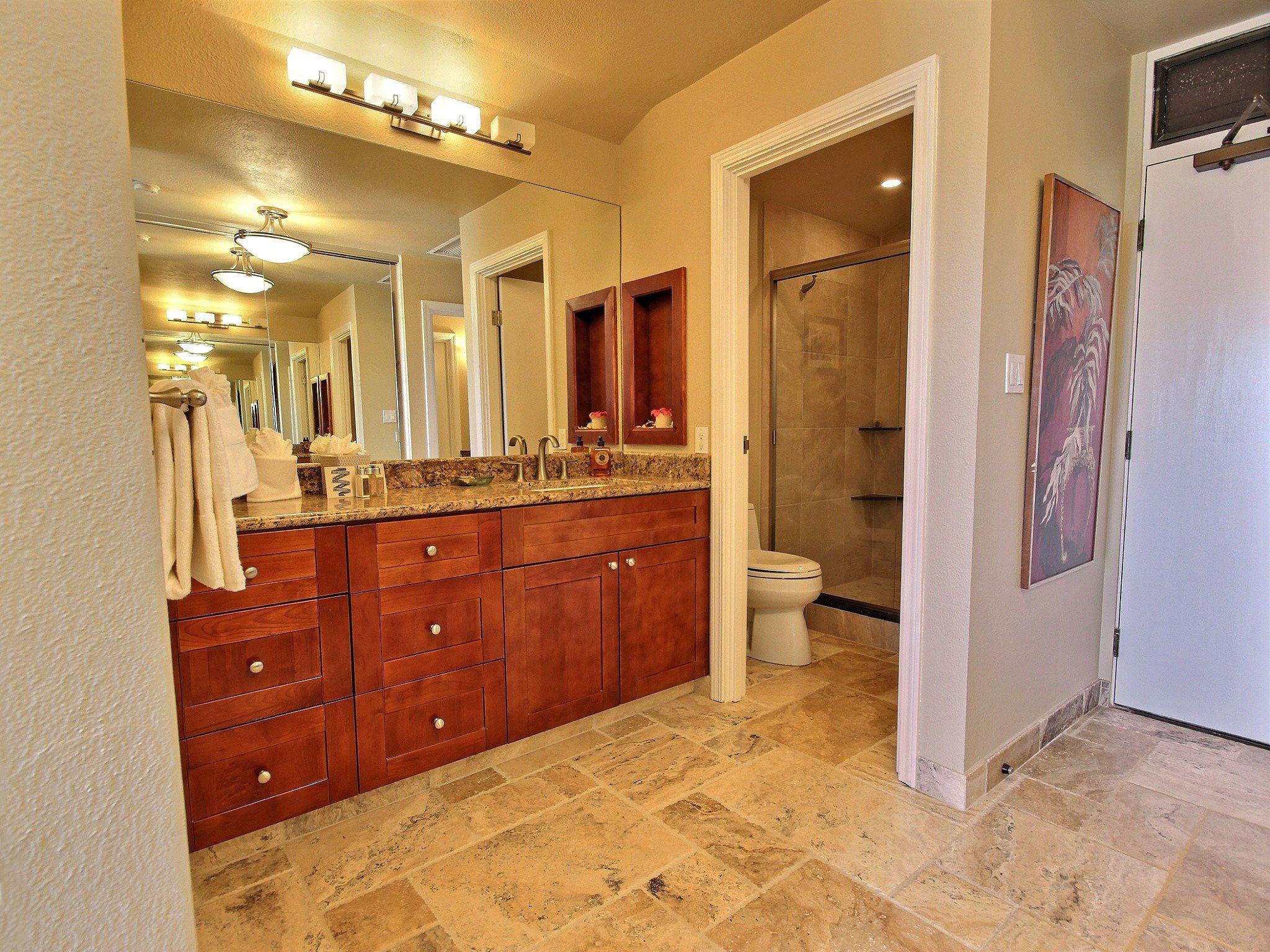 Begin your day with a mirror-lit smile and end it in soothing stone and warm wood—this bathroom completes the story of rest     KGV-19P3