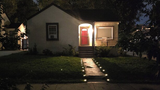 A house with a red door, a small porch, and a pathway leading to the entrance. - Clean quiet and comfortable home welcomes you (Colorado Springs)