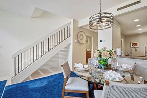 Bright, open dining with staircase views and elegant ambiance. KGV-20T8 - Kapalua Golf | Golf View 3 BR, Sleeps 9 | Car Incl. w/ 6+ Nights | KGV ML-2204 by KBM (Lahaina)