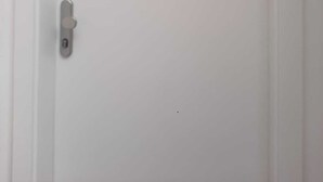 A white door with a numeric keypad lock and a small sign above it. - Charming 1BR Apartment In Top Location (Vienna)