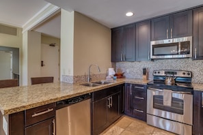   This rich, espresso-toned kitchen isn’t just functional—it’s the heart of your stay, where every meal feels like home   KGV-14P3 - Kapalua Golf | Golf View 6 BR, Sleeps 18 | Car Incl. w/ 6+ Nights | KGV ML-2225 by KBM (Lahaina)