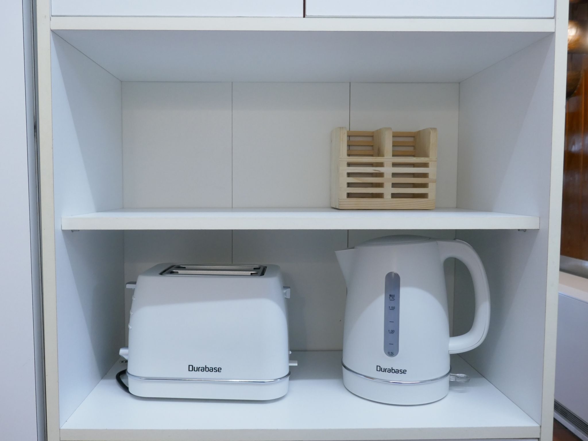 A white shelf with a toaster and a kettle labeled 'Durabase' on it.