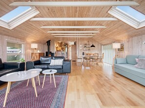 A spacious living area with a high ceiling, wooden walls, and skylights. - "Athislus" - 1.1km from the sea by Interhome (Glesborg)