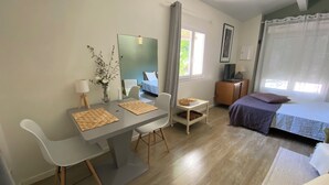 A modern bedroom with a bed, bedside table, and a desk with a chair. - Detached studio with terrace in Aix countryside property (Aix-en-Provence)