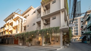 A multi-story building with balconies, a sign for 'Siam Escape by Shonen', and a street view. - Siam Escape (Bangkok)