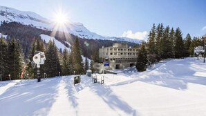 A snow-covered mountain landscape with a building that appears to be a hotel or lodge. - 3-room Apartment for 8 People - Comfort (Araches-la-Frasse)
