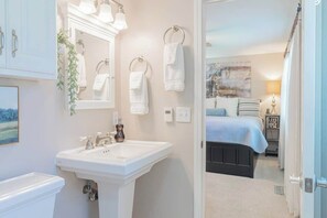 A bathroom with a white sink, mirror, and towel rack. - Truckee Mountain Retreat Family Friendly 3BR 2BA (Truckee)