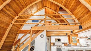 A wooden interior with a vaulted ceiling, a kitchen area, and a staircase. - The Canoe Cabin in Incline Village (Incline Village)
