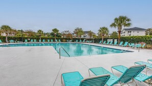 A pool area with turquoise lounge chairs and a clear blue pool. - Golf & Relax! Resort-style Condo in Myrtle Beach (North Myrtle Beach)