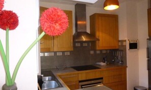 Fridge, dishwasher, coffee/tea maker, cookware/dishes/utensils