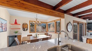 A modern kitchen with a granite countertop, stainless steel sink, and wooden ceiling beams. - Cozy Keystone Townhome Near Slopes, Poolhouse with Sauna & Hot Tub (Keystone)