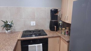 Eine Küche mit Herd, Backofen und Schränken.