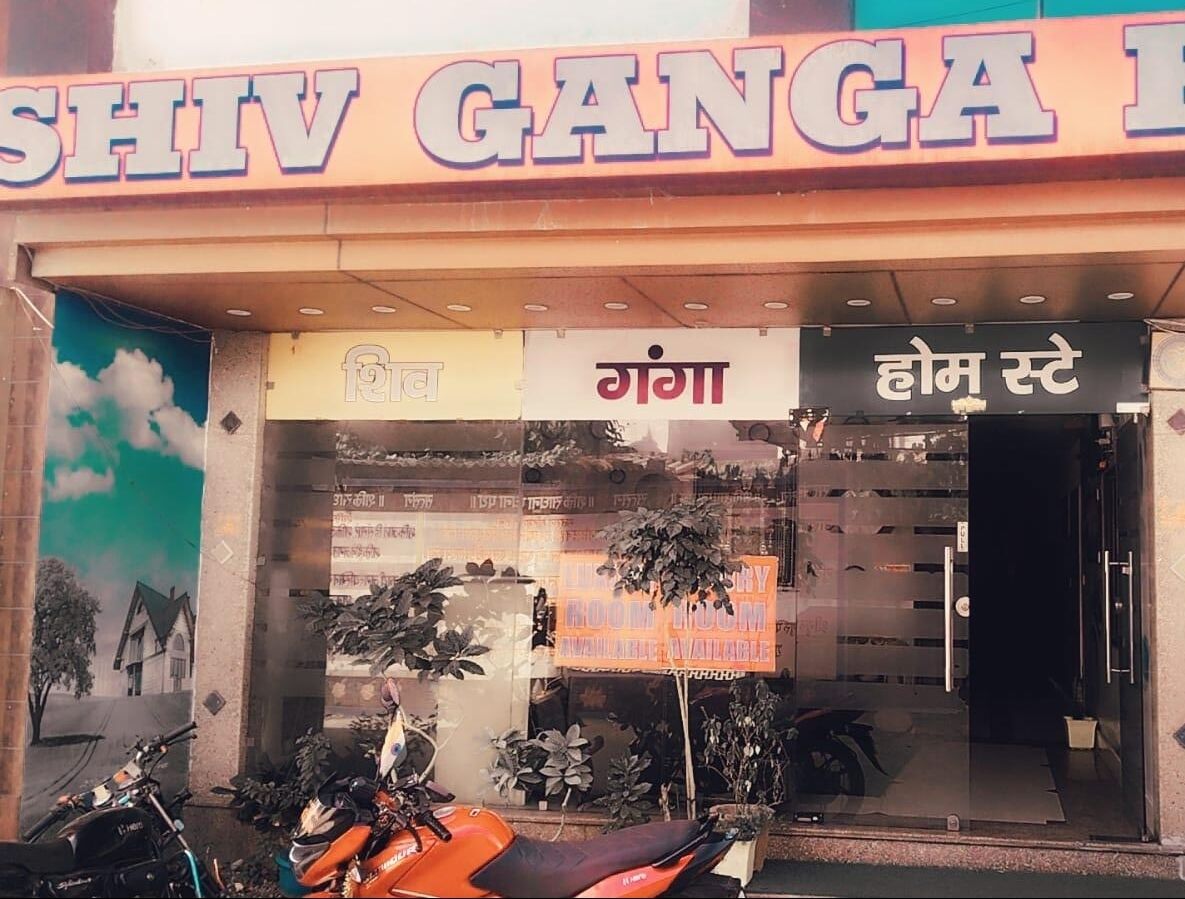 A hotel entrance with a sign reading "Shiv Ganga Hotel" and a date and time stamp indicating "Wednesday, Monday, Nov 5, 2025 11:07 AM".