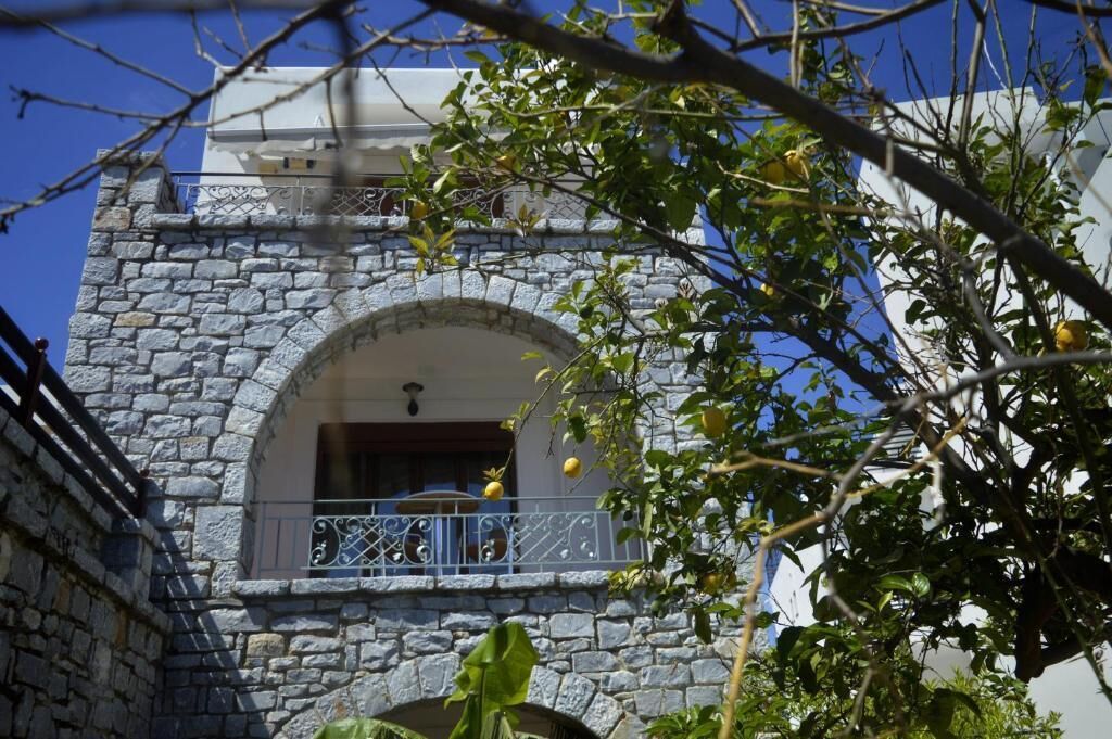 A stone building with a balcony and a window.