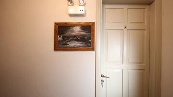 A white door with a keyhole and a doorbell.