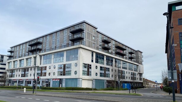 A modern multi-story building with large windows and balconies. - Paramount Nest (Swindon)