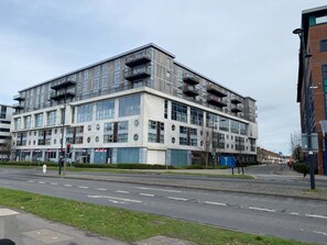 A modern multi-story building with large windows and balconies. - Paramount Nest (Swindon)