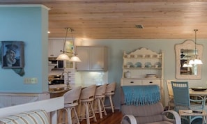 A dining area with a wooden ceiling, white cabinets, and a blue wall. - Gulf Beach Retreat, just steps from the sand of Anna Maria! Private heated pool (Holmes Beach)