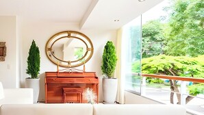 A modern room with a large mirror, a wooden cabinet, and potted plants. - ✶ Kotosh Residence ✶ LUXURY Best Location | Piano (Miraflores)