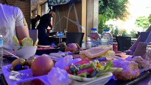 A dining table with various food items and a bottle of water. - el boujdaini (Tangier)