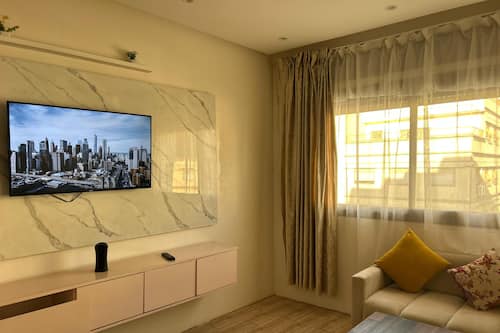 Appartamento Standard, vista città | Area soggiorno | Smart TV 43 cm con canali via cavo, Netflix, lettore DVD