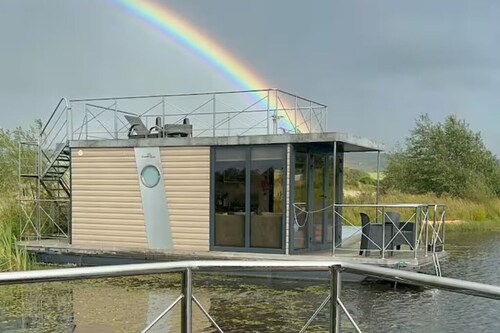 Boat house on a peaceful lake in Scotland