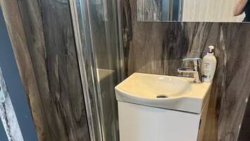 Shower, towels, soap, toilet paper