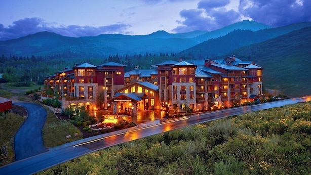 A multi-story hotel with a stone facade, multiple balconies, and a well-lit entrance. - New Sunrise Gondola at Ski-in/out Condo Sunrise Lodge in Canyons Village Jan 03 (Park City)