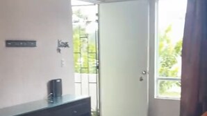 Um quarto com uma mesa, uma porta e uma janela.