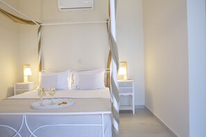 A neatly arranged bedroom with a four-poster bed, bedside tables with lamps, and a tray with glasses and a snack. - Comfortable 3 bedroom Villa with swimming pool and sea view. Pet-Friendly (Lefkada)