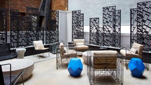 A modern outdoor seating area with metal furniture and a decorative black lattice partition. -  Time Square Hilton Studio Premier available for New Year's Eve in New York City (New York)