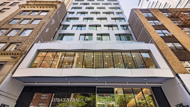 A modern building with a glass facade, labeled "The Central 5th Hilton Club". -  Time Square Hilton Studio Premier available for New Year's Eve in New York City (New York)