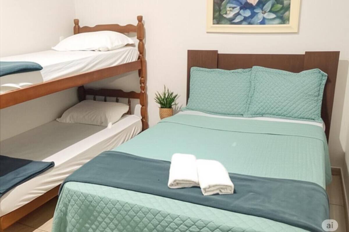 A room with a bunk bed, a single bed, and a small potted plant.