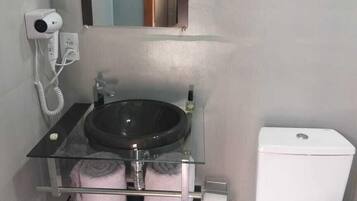 Shower, hair dryer, towels, toilet paper